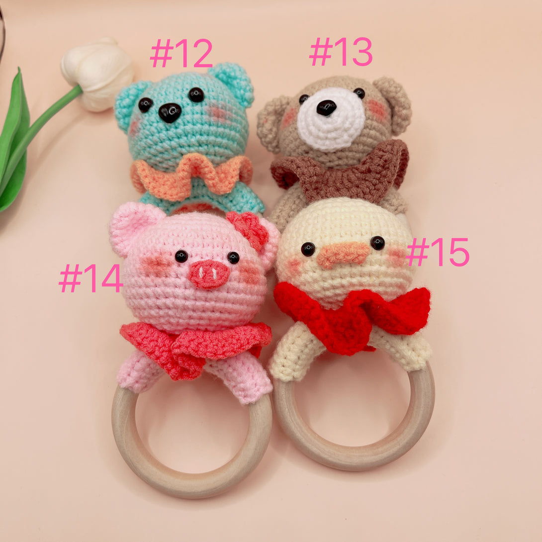 Stitchery Zone Animal Crochet Rattle set featuring handmade blue bear, brown bear, pink pig, and yellow chick baby toys