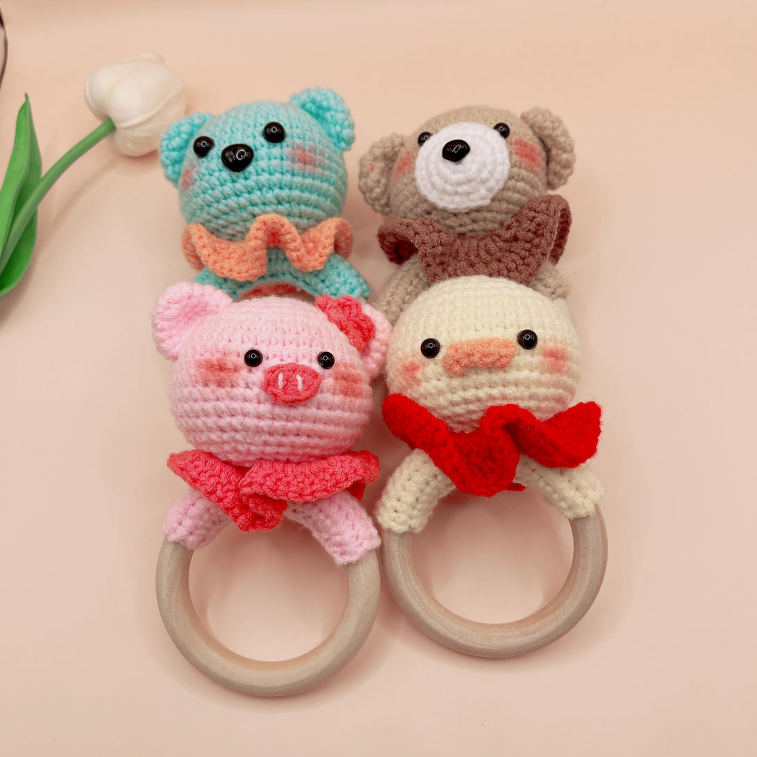 Animal Crochet Rattle baby toys by Stitchery Zone featuring handmade crocheted bear, pig, duck, and dog with wooden rings