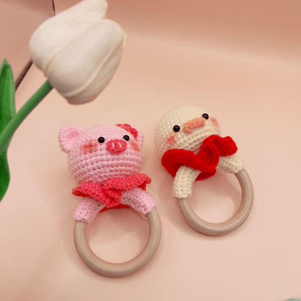 Stitchery Zone Animal Crochet Rattle baby toys featuring pink pig and white duck designs with wooden rings