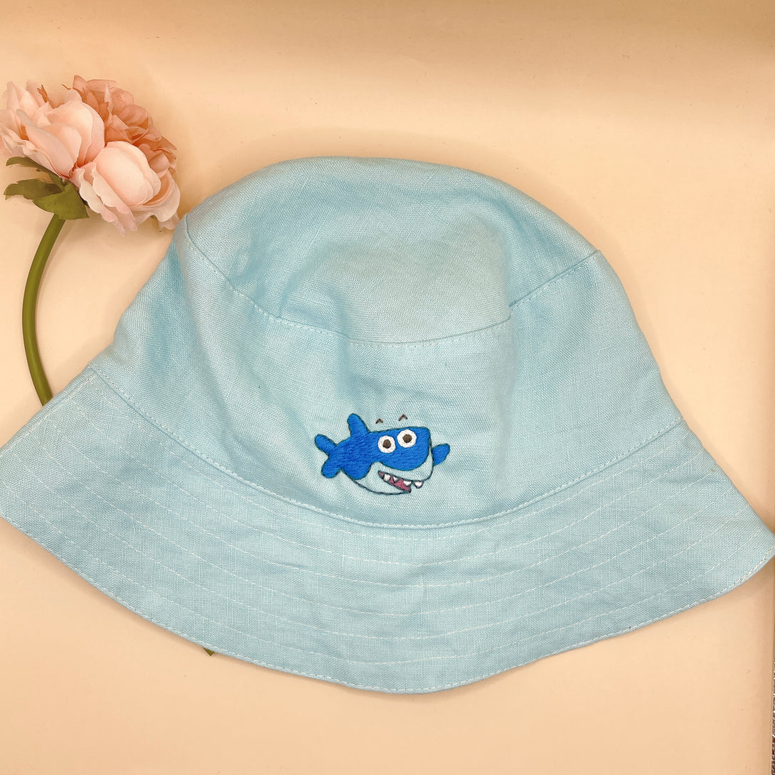 Stitchery Zone Baby Shark Embroidered Linen Baby Hat in light blue with cute shark design