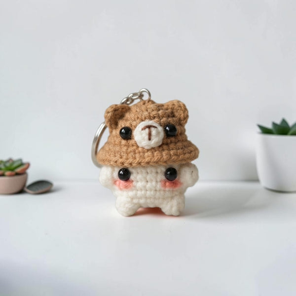 Handcrafted crochet bear keychain in brown and white, featuring cute eyes and a hat, perfect for personalizing your keys