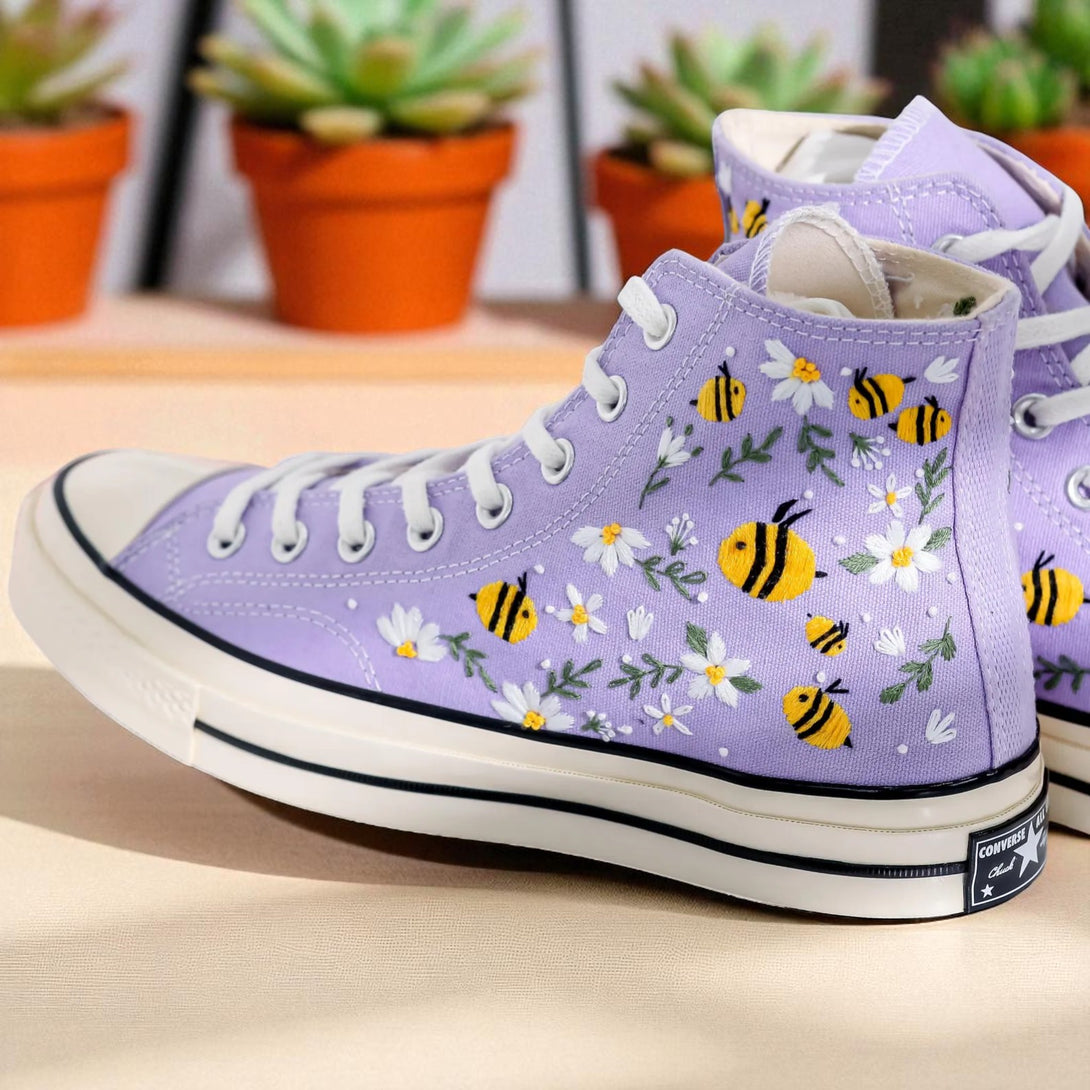 Stitchery Zone Bee Embroidered Sneakers in lavender with yellow bee and white flower embroidery on high-top canvas shoes
