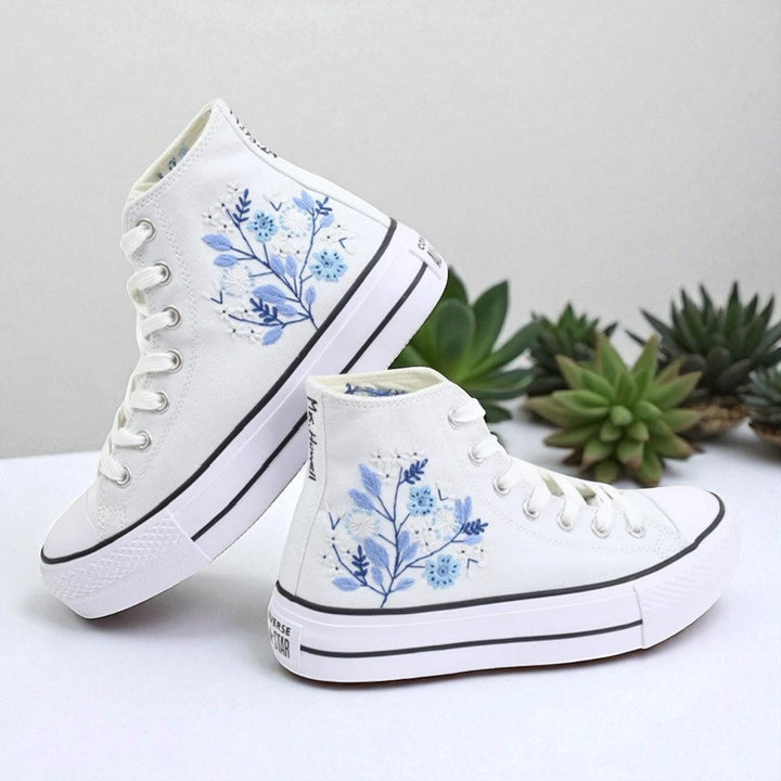 White embroidered high top Converse Shoes Wedding with blue floral design on side and white rubber sole