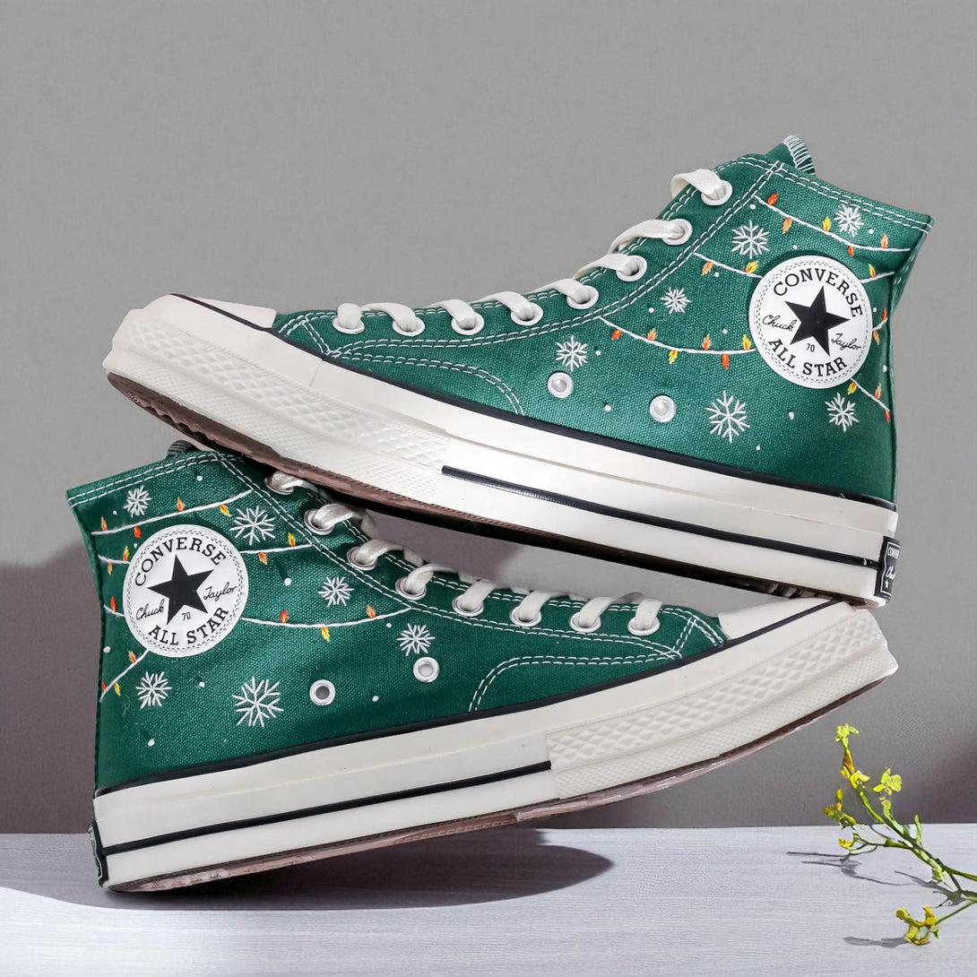 Converse embroidered green high top Christmas Chucks with snowflake and string light details and white All Star sole