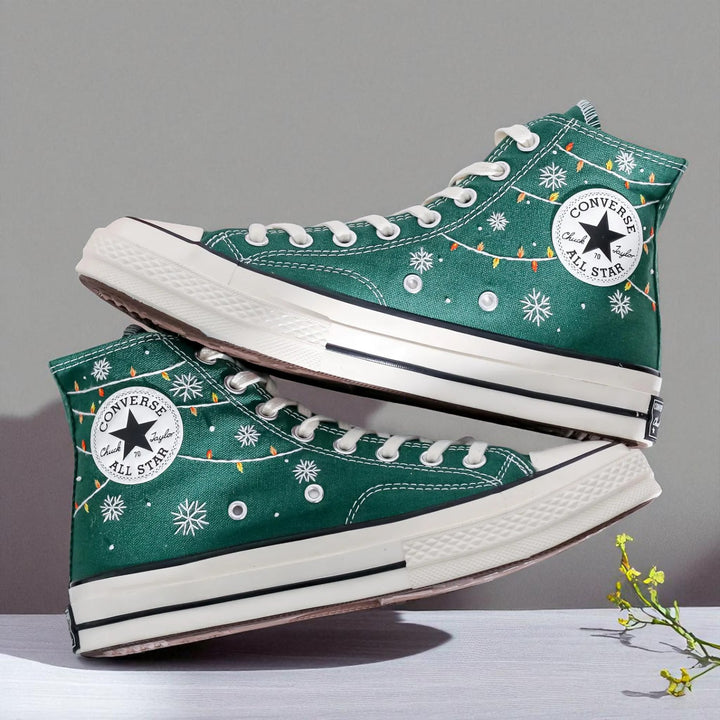 Converse embroidered green high top Christmas Chucks with snowflake and string light details and white All Star sole