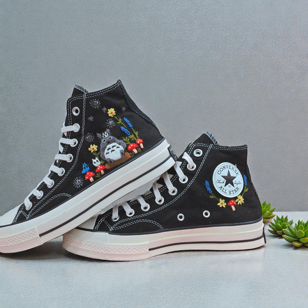 Cute Converse embroidered shoes featuring vibrant floral designs on a black canvas background