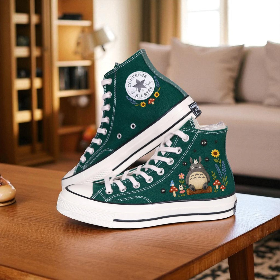 Cute Converse embroidered shoes with Totoro design and floral details on a cozy indoor setting