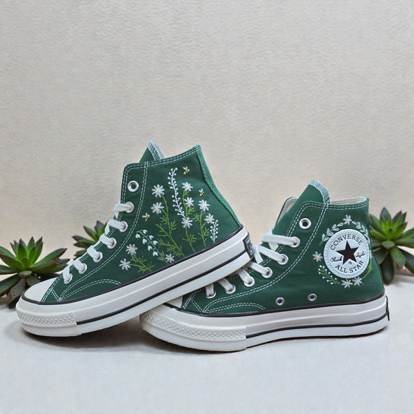 Dark green Converse high-top shoes with floral embroidery and classic rubber sole