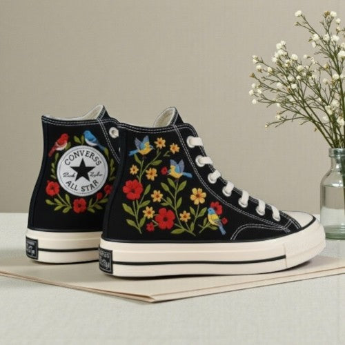 Floral Converse embroidered high-top shoes featuring vibrant flower designs on a black background