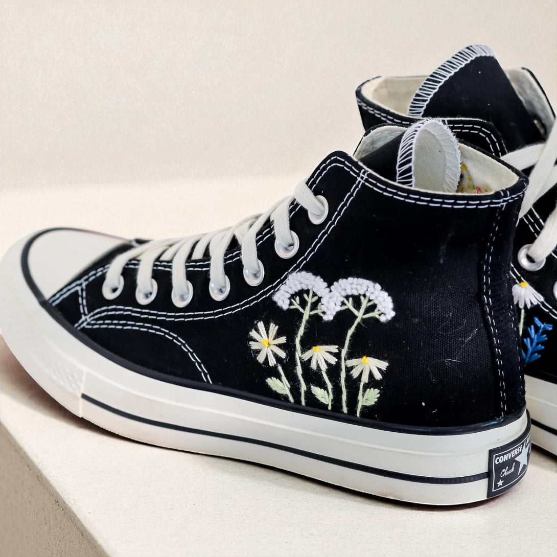 Floral Converse High Tops in black with vibrant embroidered flower designs on the sides