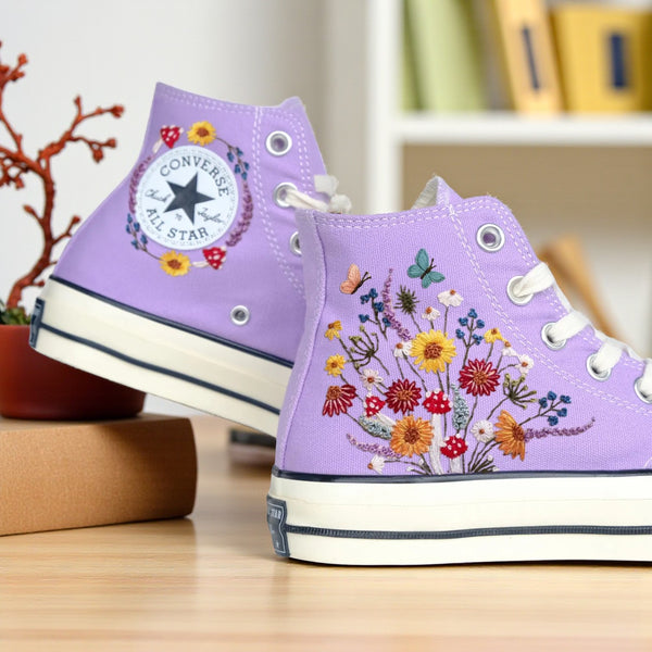 Converse embroidered shoes with colorful flowers and butterflies, featuring designs of shoes with mushrooms