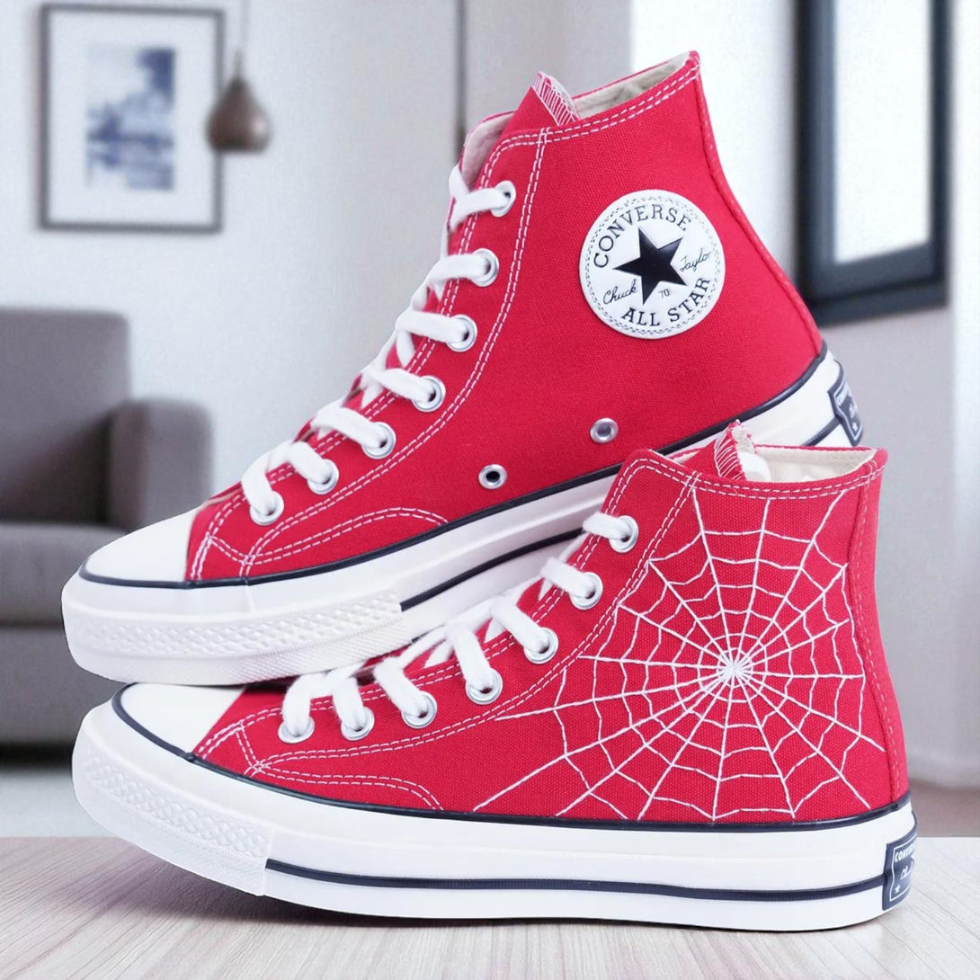 Red embroidered high top Spider Web Converse sneakers with white web design and classic logo