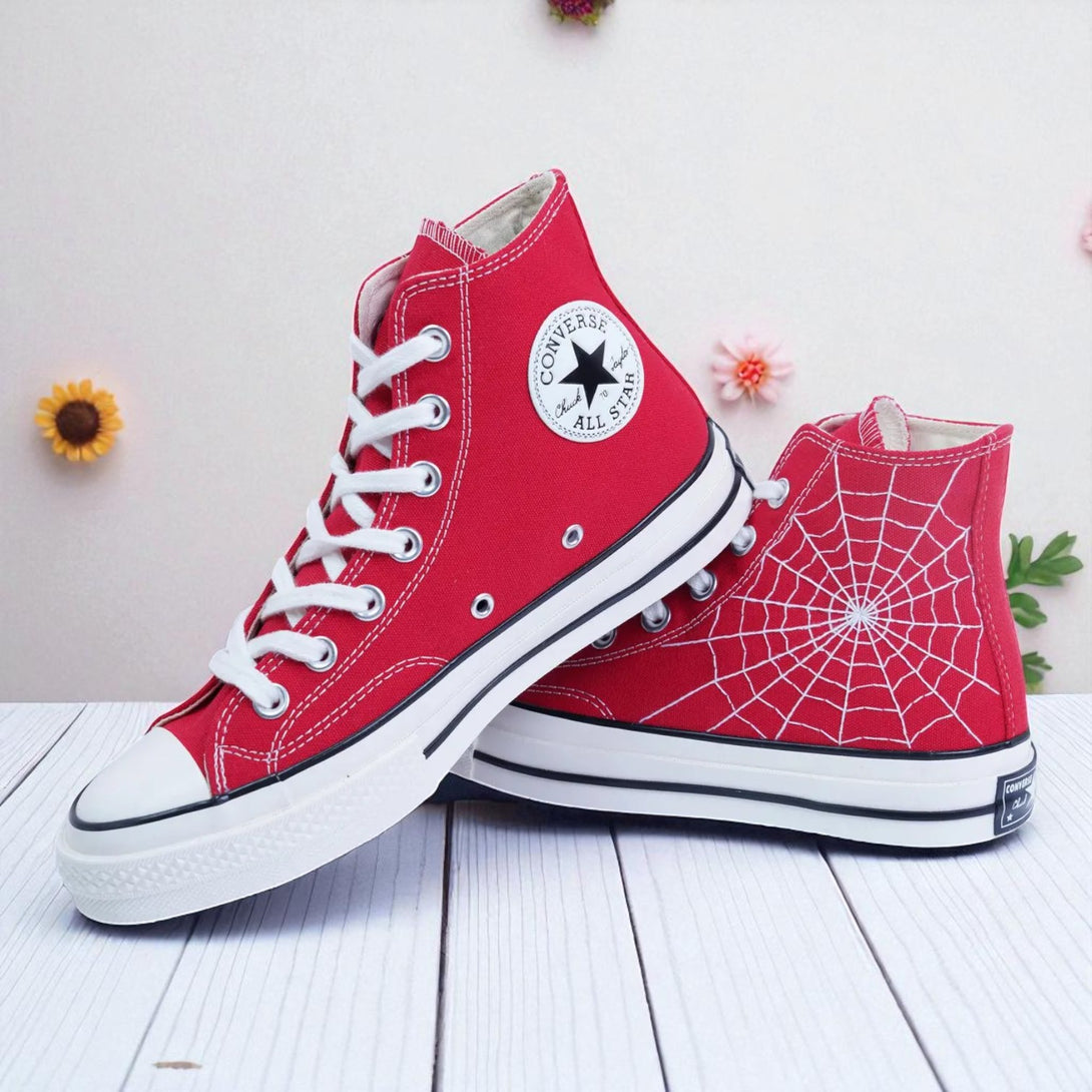 Red embroidered high top Spider Web Converse with white laces, rubber sole and Converse All Star patch