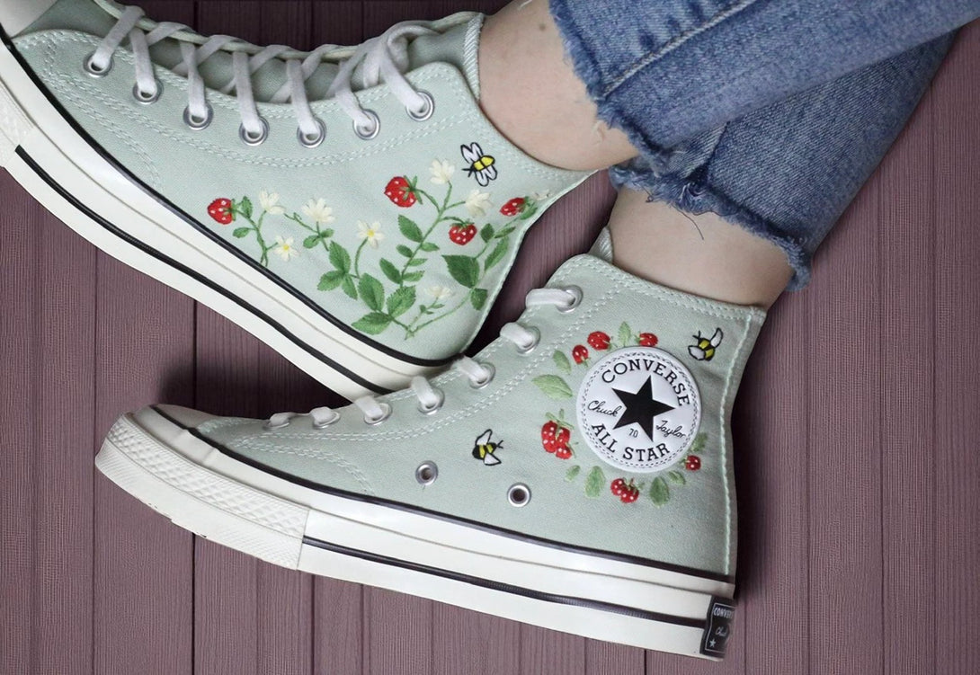 Stitchery Zone embroidered light green high top strawberry converse with red strawberries bees and leafy vines worn with frayed jeans