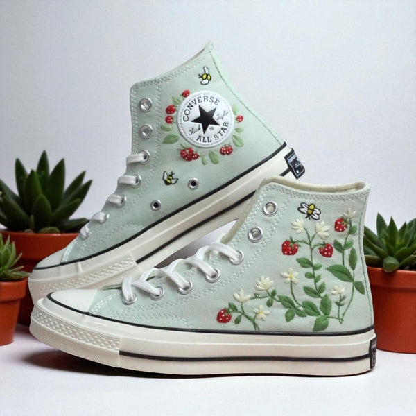 Stitchery Zone embroidered high top strawberry converse with floral and bee designs on mint canvas