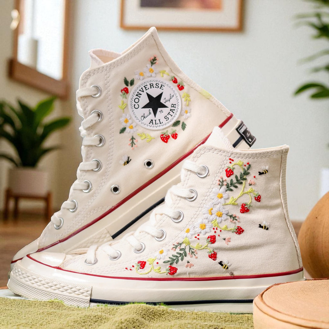 Converse embroidered shoes featuring a strawberry design and vibrant floral accents