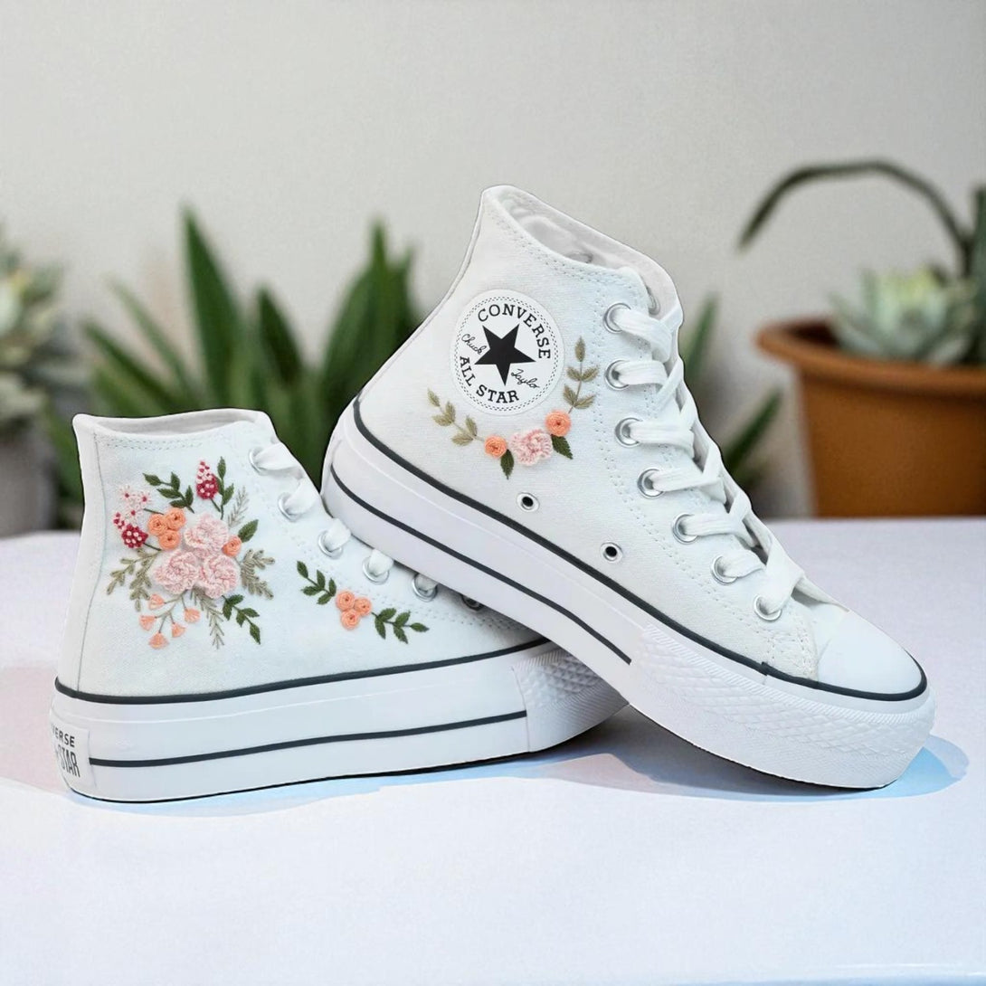 White Converse embroidered high top shoes with pink floral embroidery and classic rubber sole