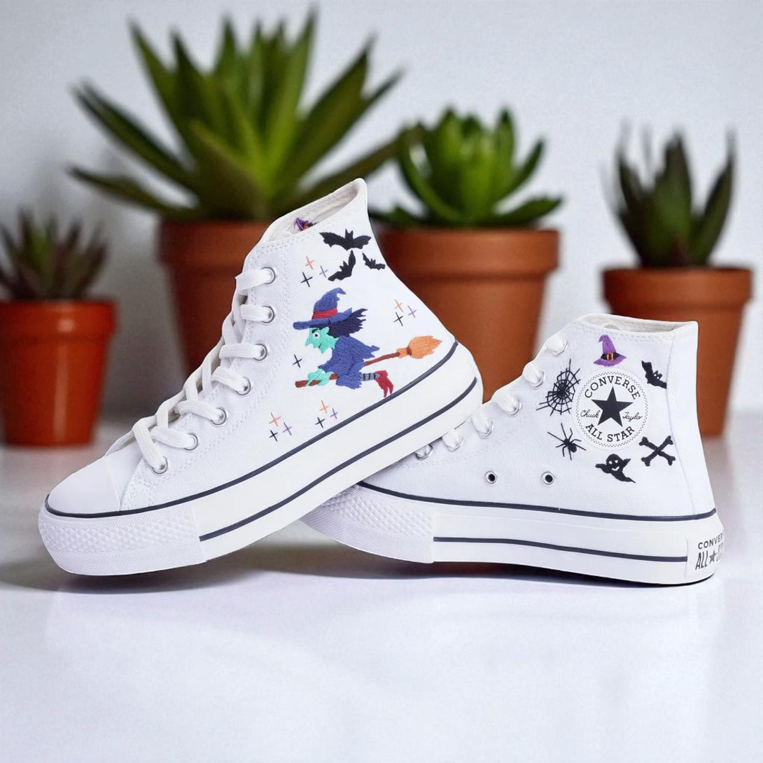White embroidered Witch Converse high top shoes with colorful witch broom and bat designs on canvas