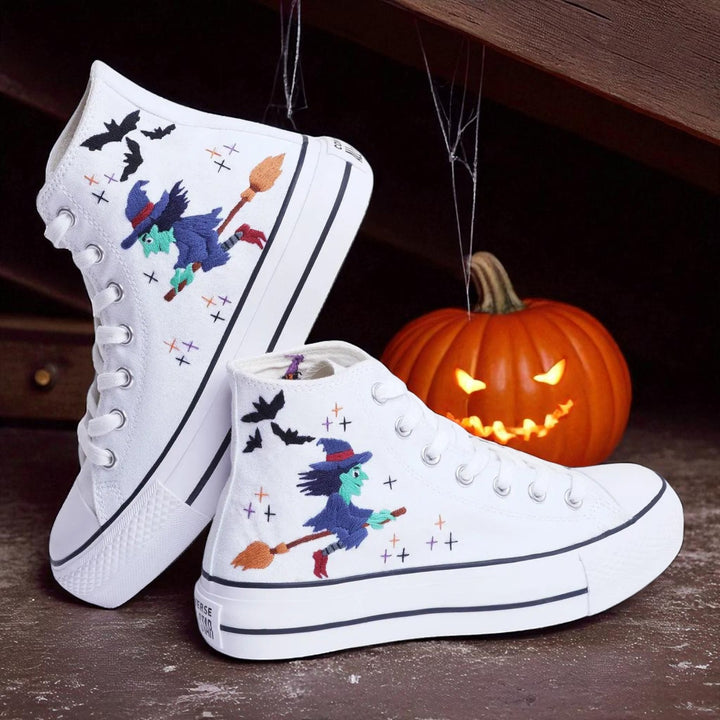 Witch Converse white high top embroidered shoes with flying witch broom bats and Halloween pumpkin backdrop