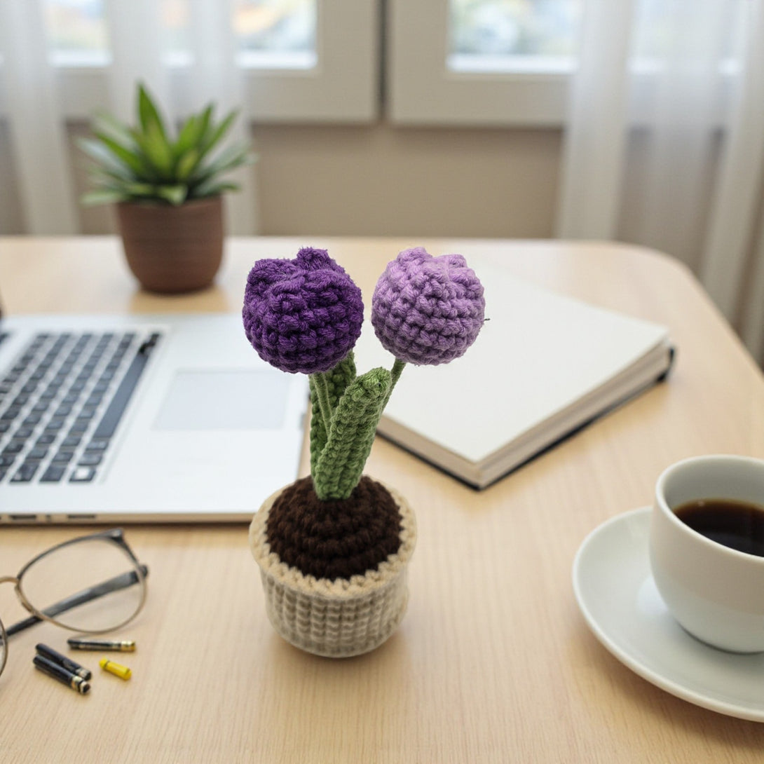 Crochet tulip in pot featuring vibrant purple flowers and green leaves, ideal for home decor