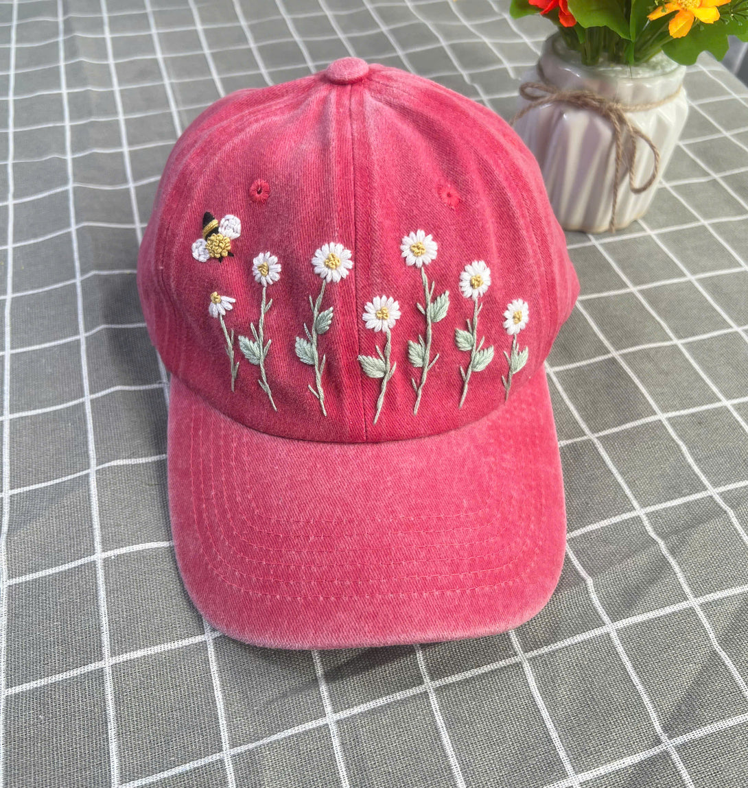 Stitchery Zone custom floral embroidery cap in pink with white daisies and bee design on front