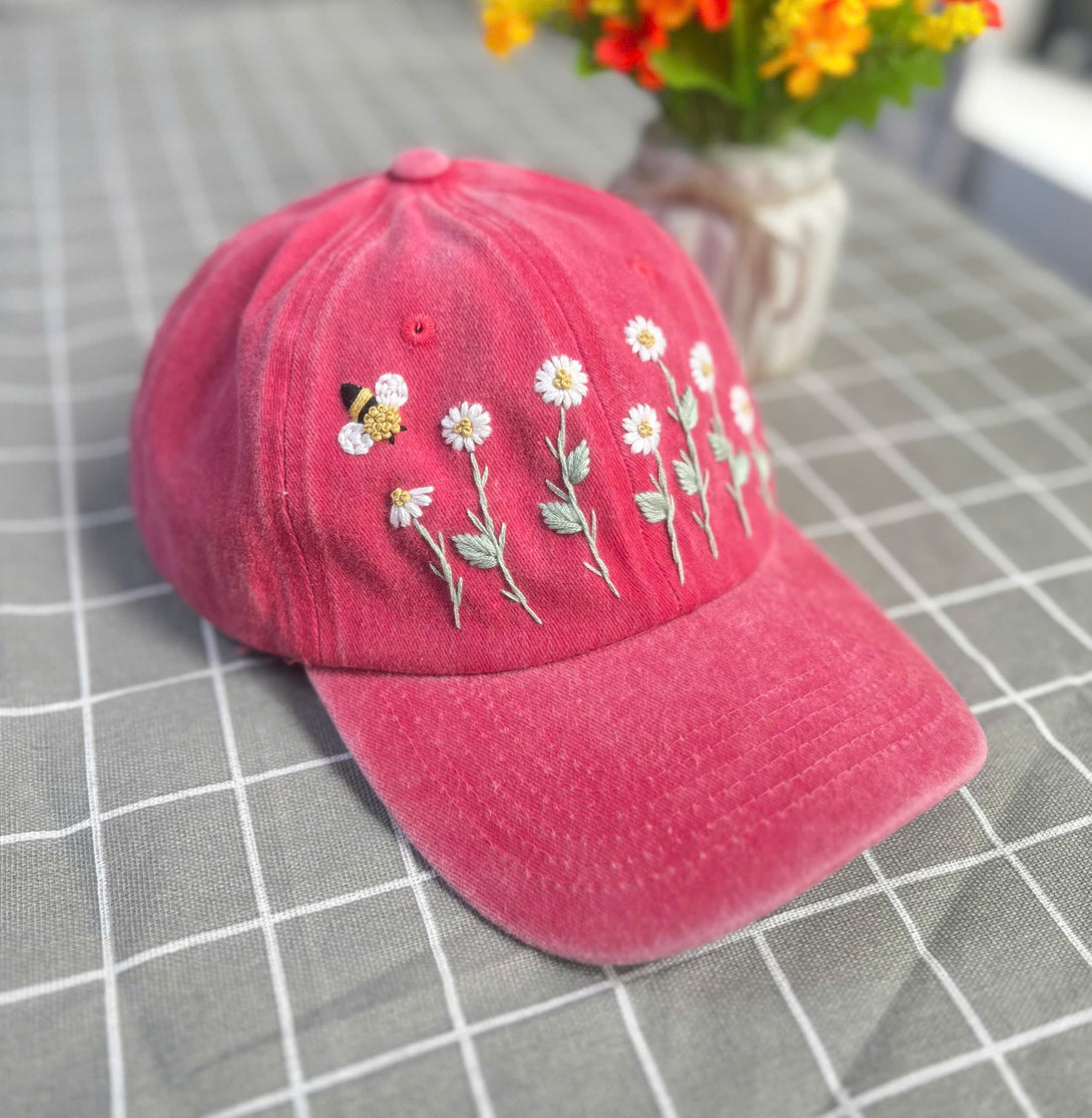Stitchery Zone custom floral embroidery cap in pink with daisy flowers and bee design on front