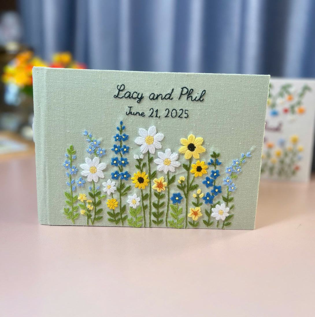 Custom floral guest book for weddings by Stitchery Zone with embroidered flowers and personalized names