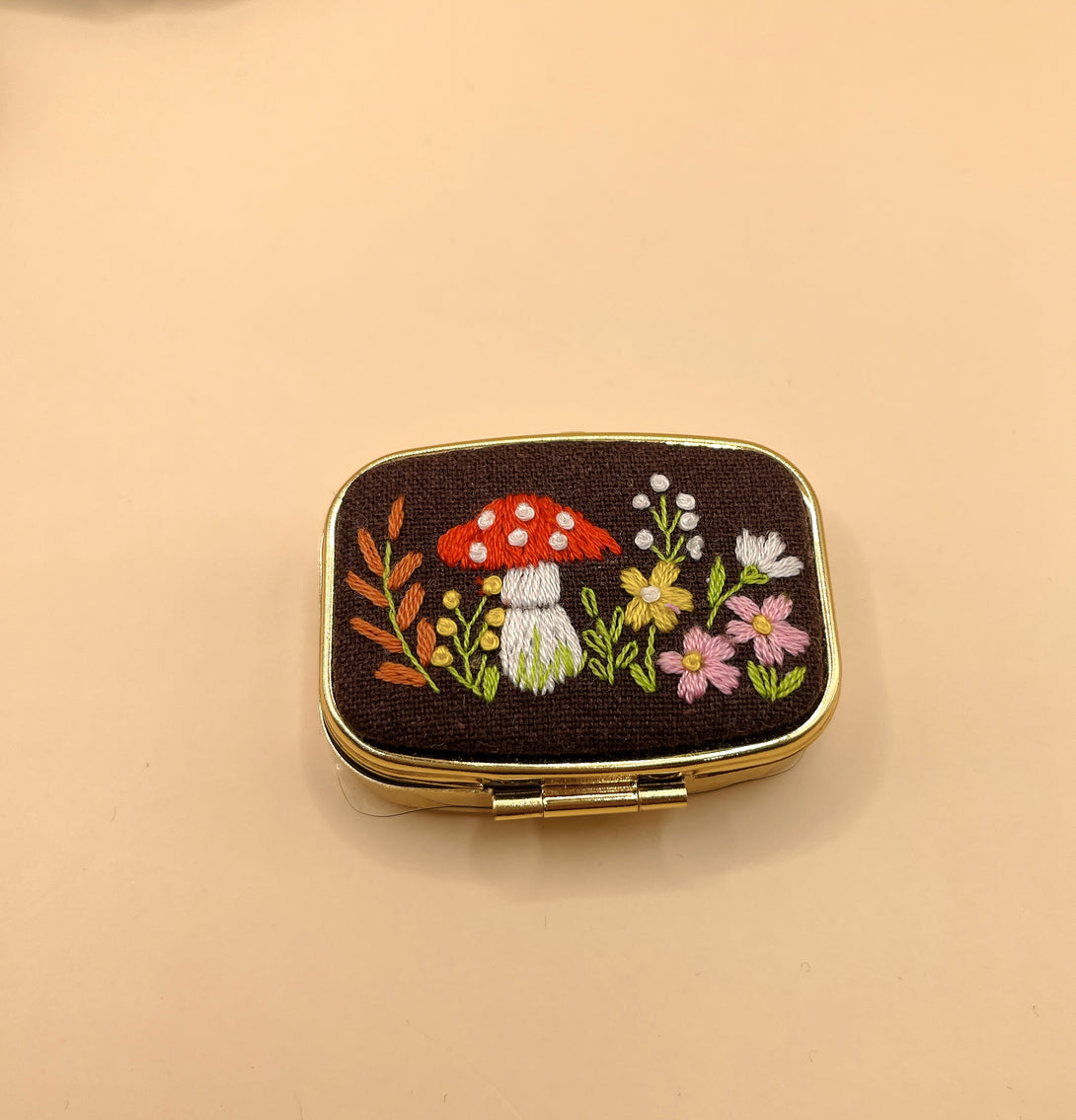Stitchery Zone mirror compact with embroidered mushroom and floral design on custom jewelry box