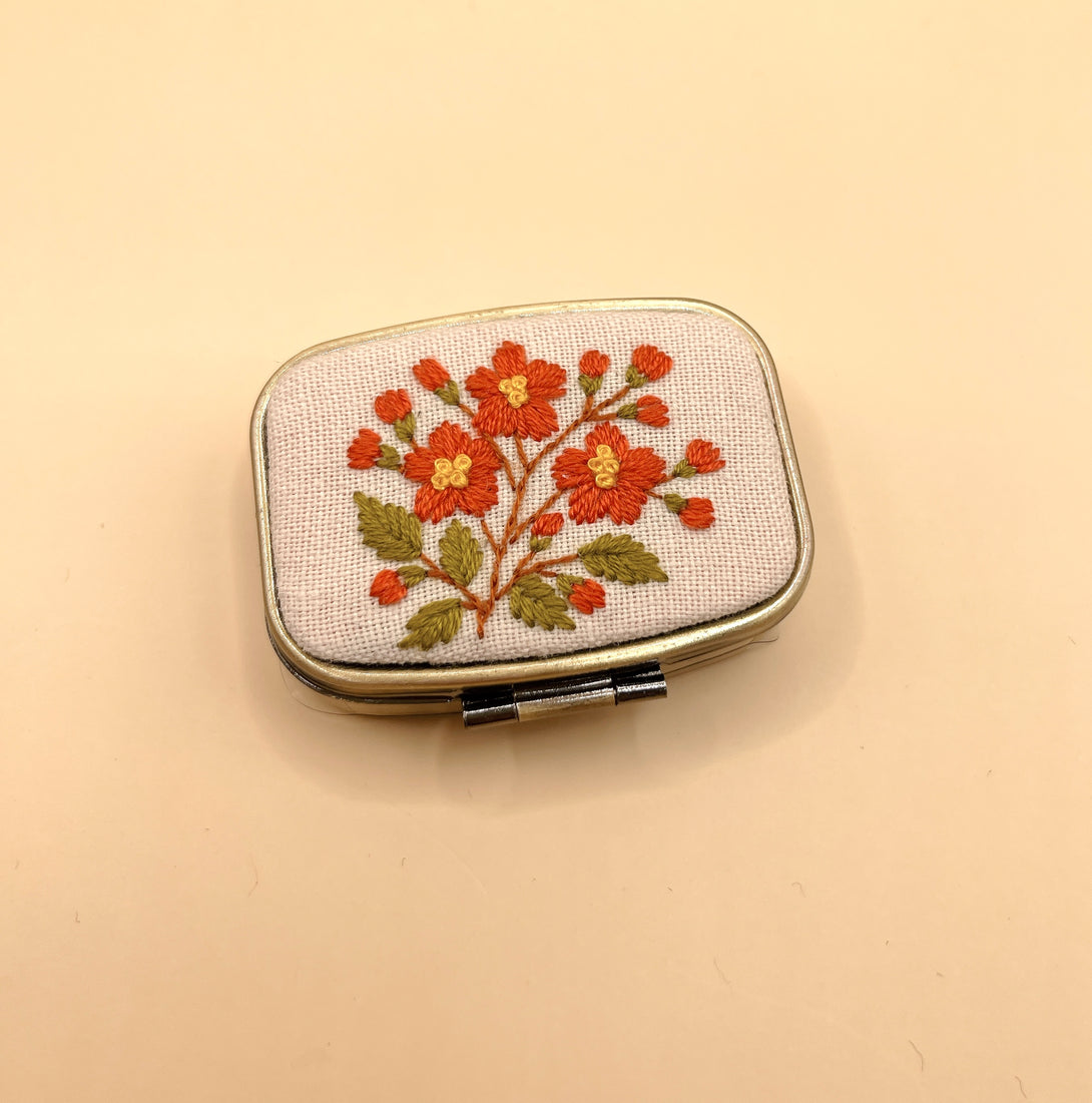Stitchery Zone custom jewelry box with embroidered orange floral design and metal frame mirror