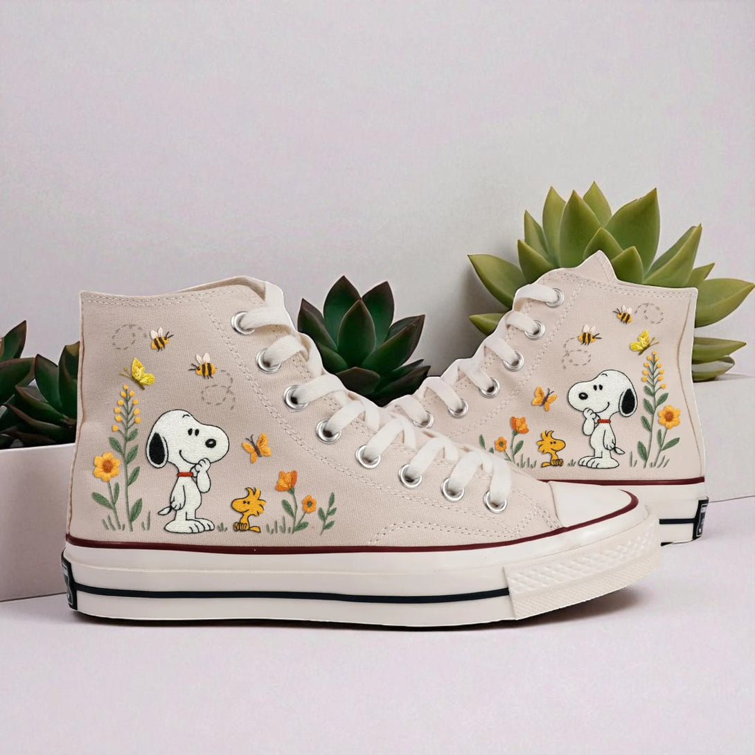 Cute Converse high-top shoes with embroidered Snoopy and floral designs on a light background