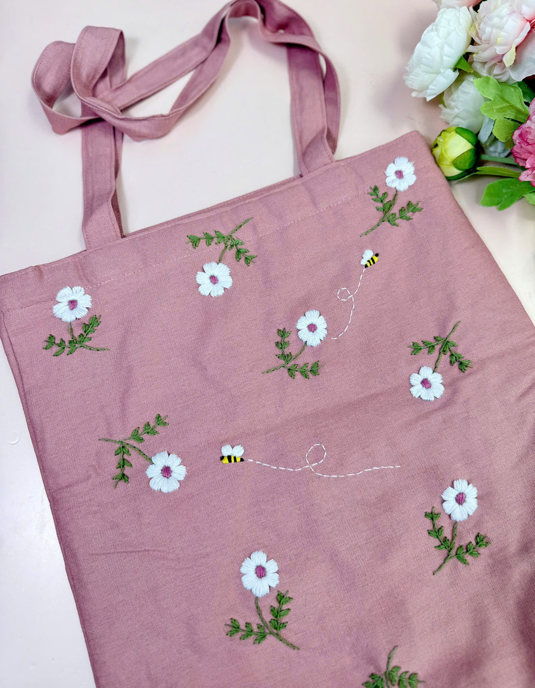 Pink Daisy and Bee Embroidered Tote Bag with white flowers and green leaves from Stitchery Zone