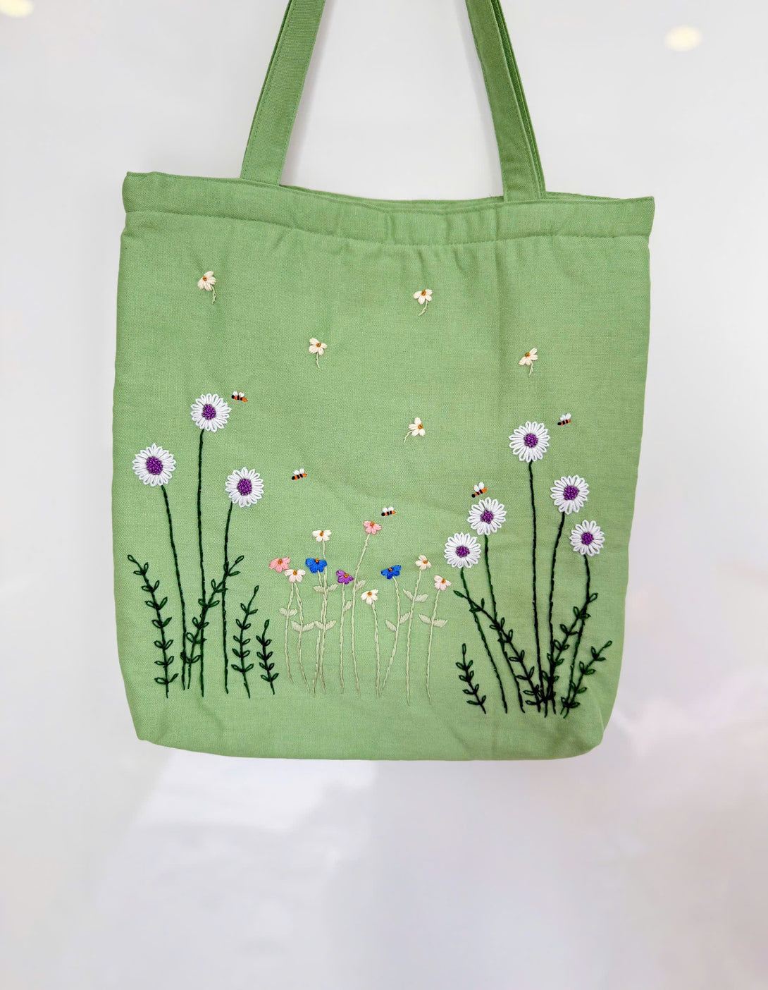 Green Daisy Embroidered Tote Bag from Stitchery Zone featuring purple and white daisies with bees design