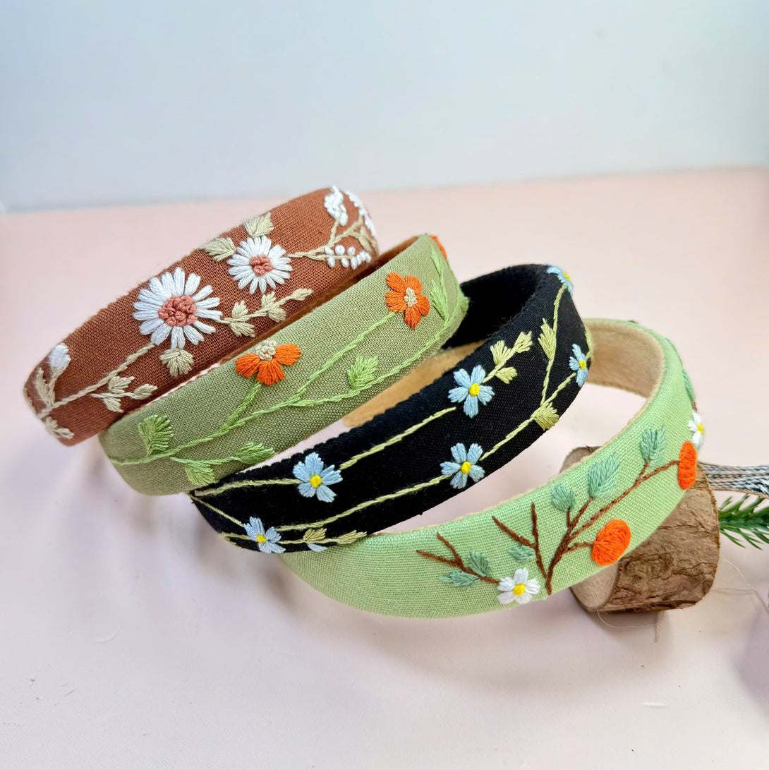Stitchery Zone embroidered custom headbands with floral designs in brown green and black colors