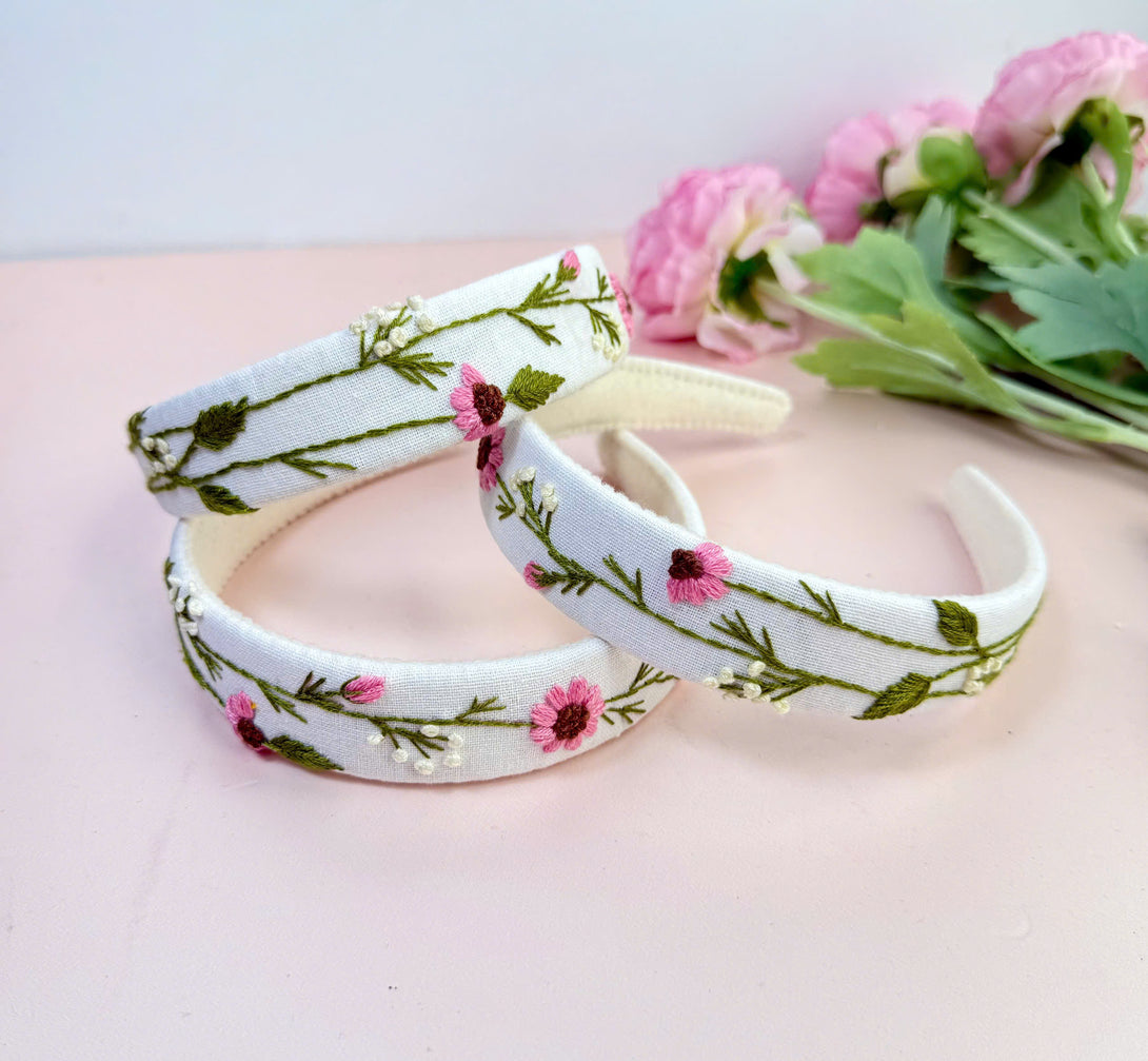 Stitchery Zone white fabric Embroidered Custom Headbands with pink and green floral designs