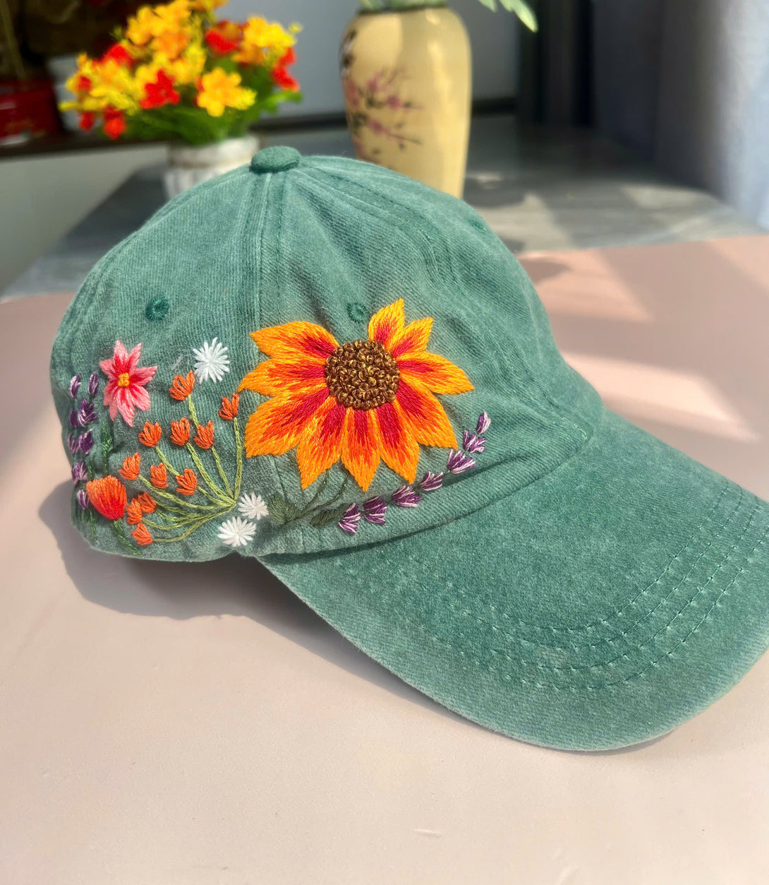 Stitchery Zone embroidered green hat featuring colorful floral design gift for flower lovers hat