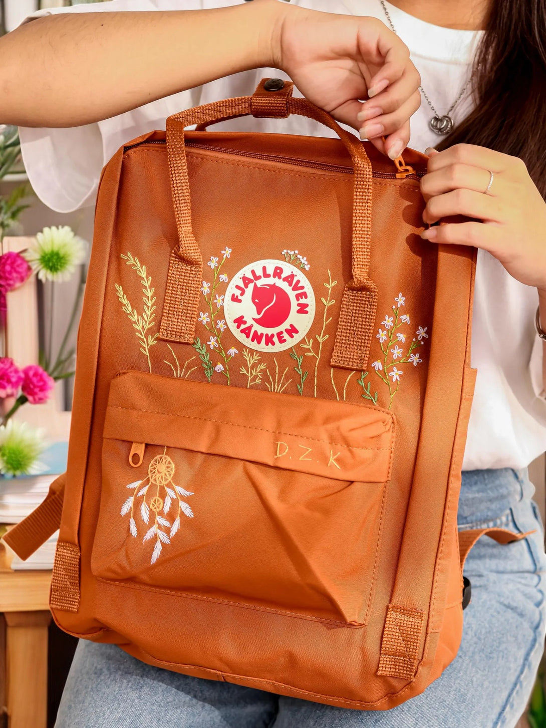 Stitchery Zone stylish orange backpack with floral embroidery, perfect for back to school backpacks.