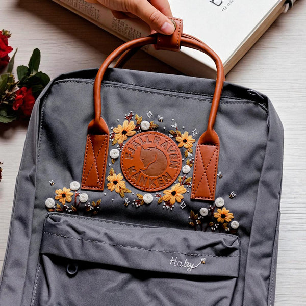 Stitchery Zone Fjallraven Kanken Backpack gray with leather handles floral embroidery and personalized Haley name