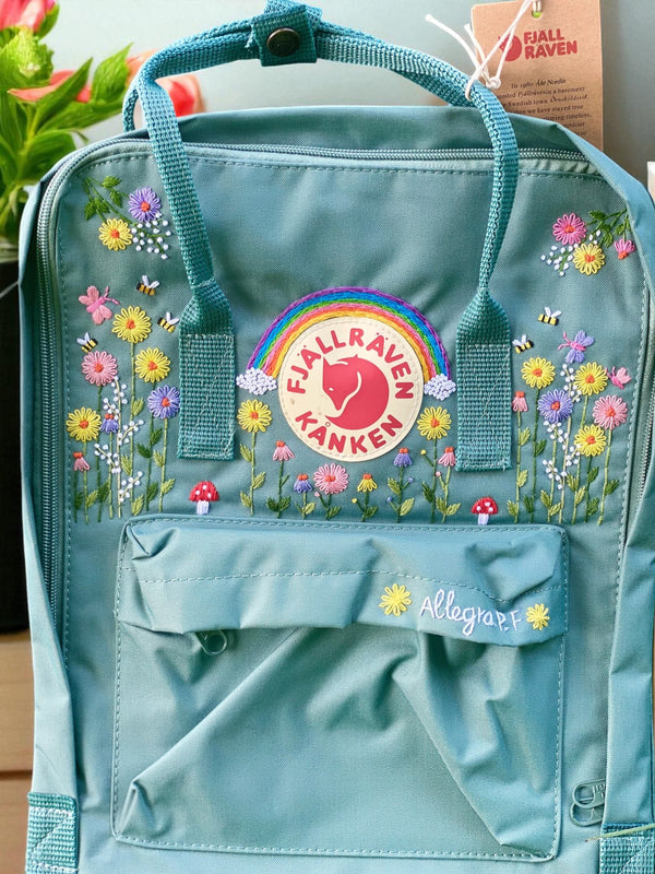 Stitchery Zone Fjallraven Kanken Mini Backpack teal green with embroidered wildflowers rainbow logo and front zip pocket