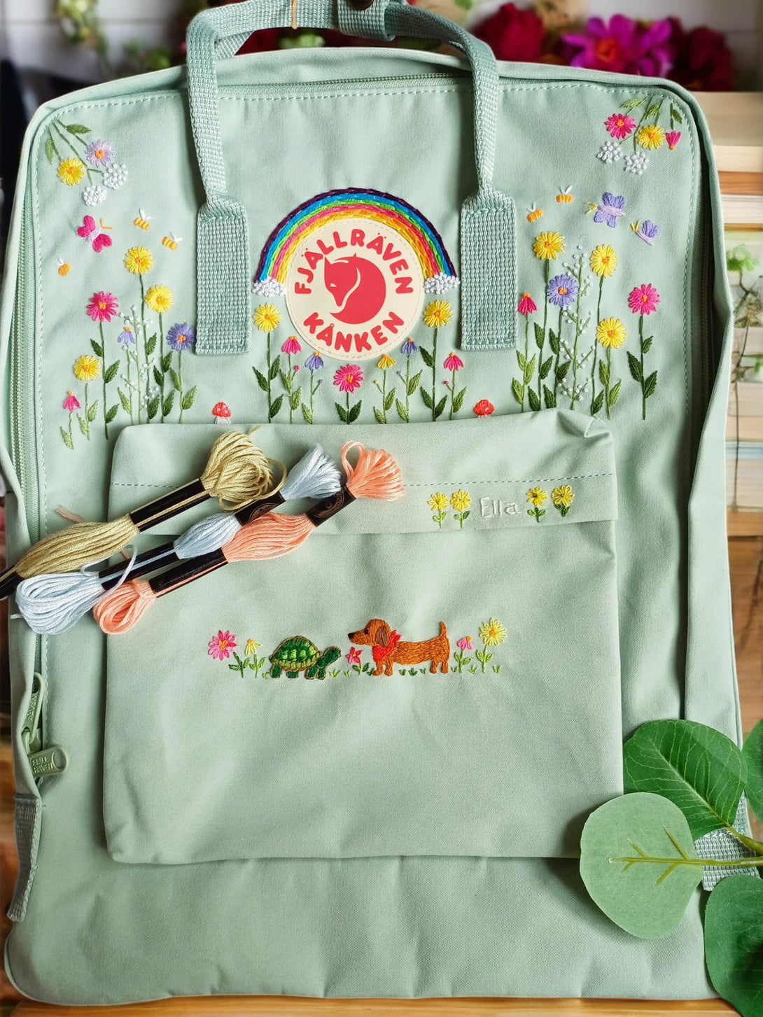 Stylish green backpack for school with floral embroidery and a front pocket for essentials