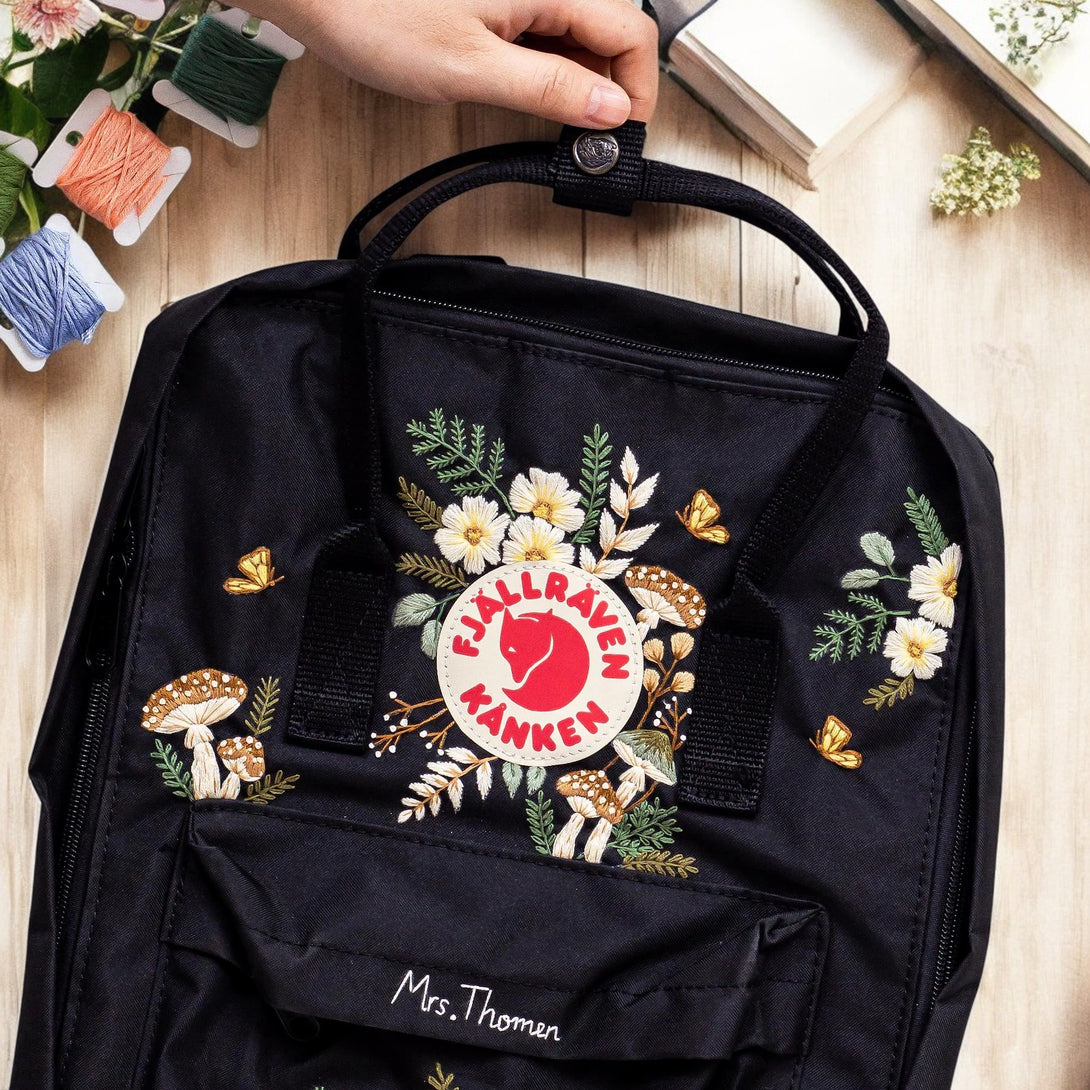 Fjallraven Kanken Laptop 15 Backpack in black with floral embroidery and iconic logo