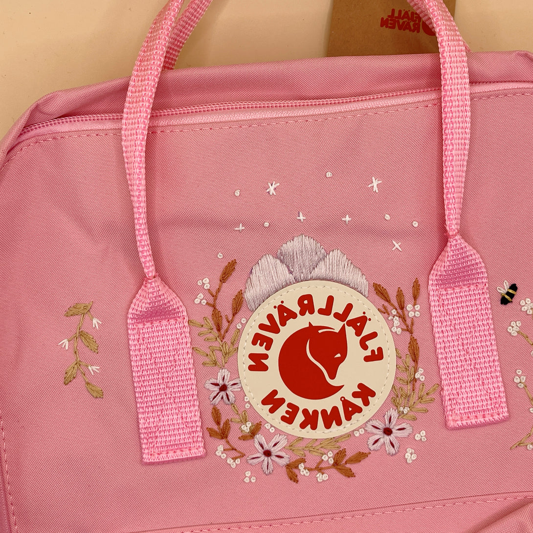 Pink personalized children's backpack by Stitchery Zone with floral embroidery and sturdy handles