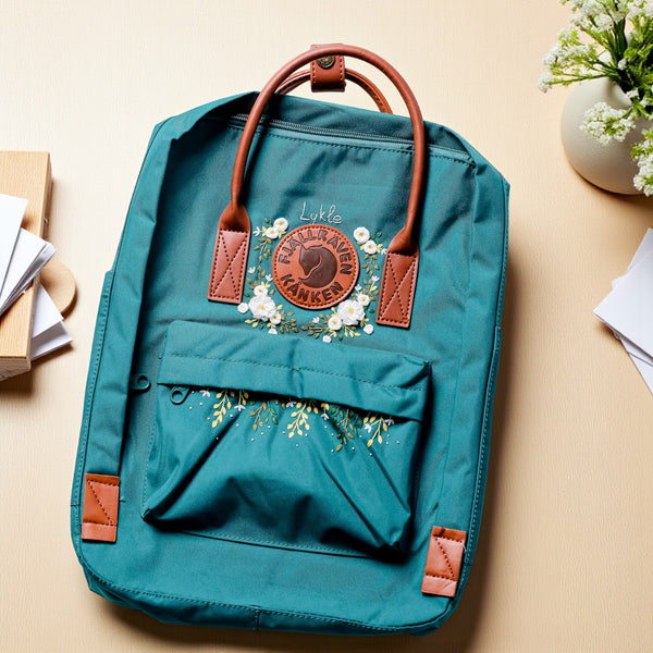 Stitchery Zone teal school backpack with floral design and leather accents for stylish students