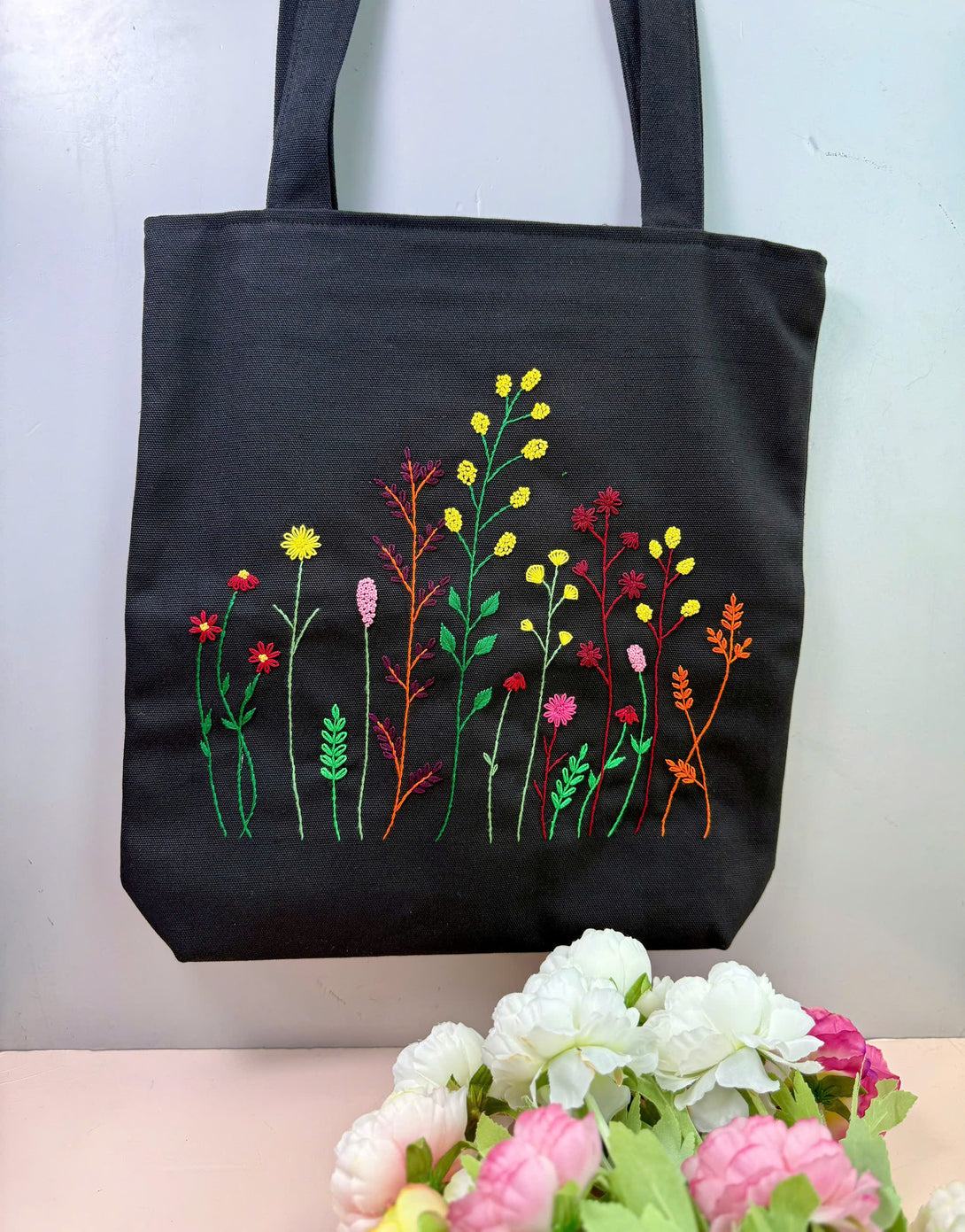 Stitchery Zone black bag with colorful floral embroidery tote design and long handles
