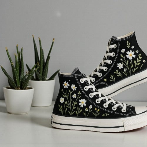 Black Converse shoes with flower embroidery, perfect for stylish casual wear