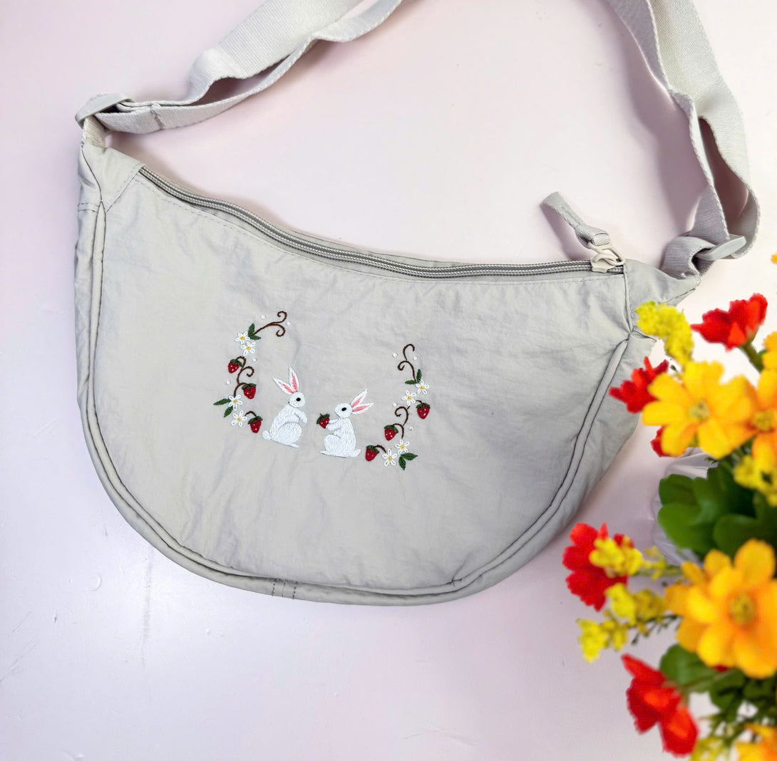 Flower Garden Hand Embroidered Cross Bag in light gray with white bunny and strawberry embroidery by Stitchery Zone