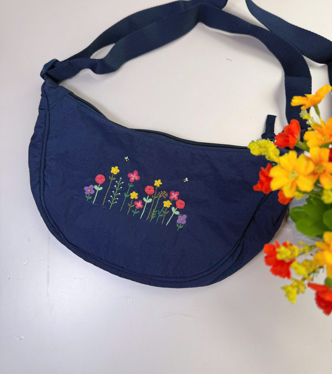 Navy blue Flower Garden Hand Embroidered Cross Bag with colorful floral design and adjustable strap