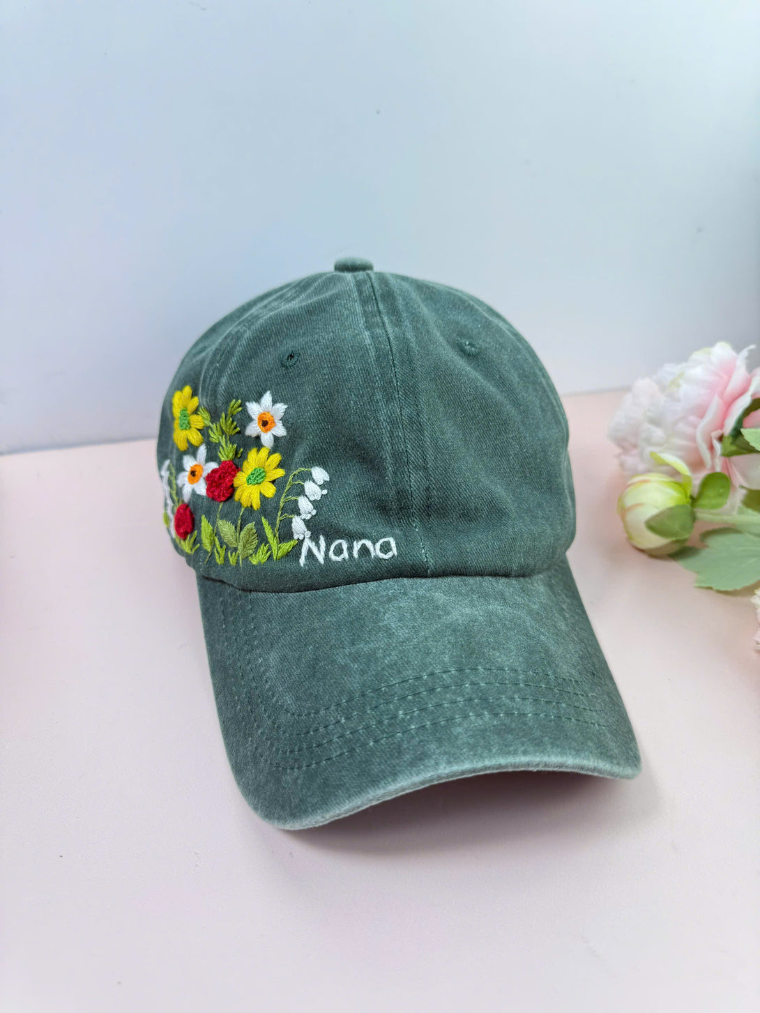 Flower Garden Personalised Embroidered Hat in green with colorful floral design and Nana text by Stitchery Zone