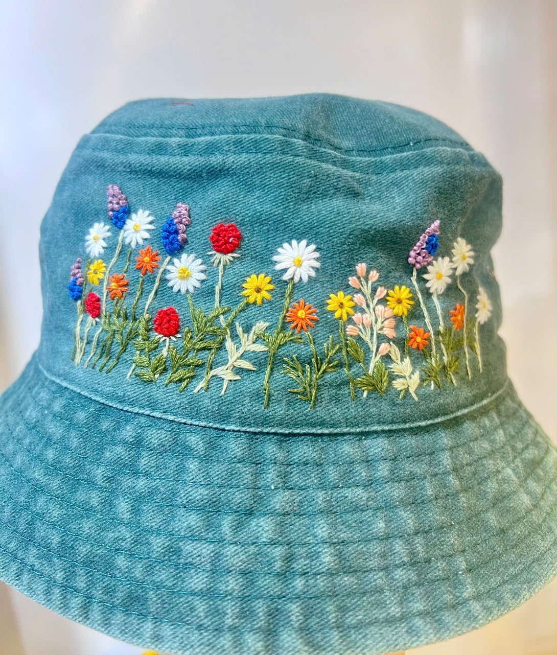 Stitchery Zone Flower Hand Embroidered Bucket Hat in blue with colorful floral embroidery detail