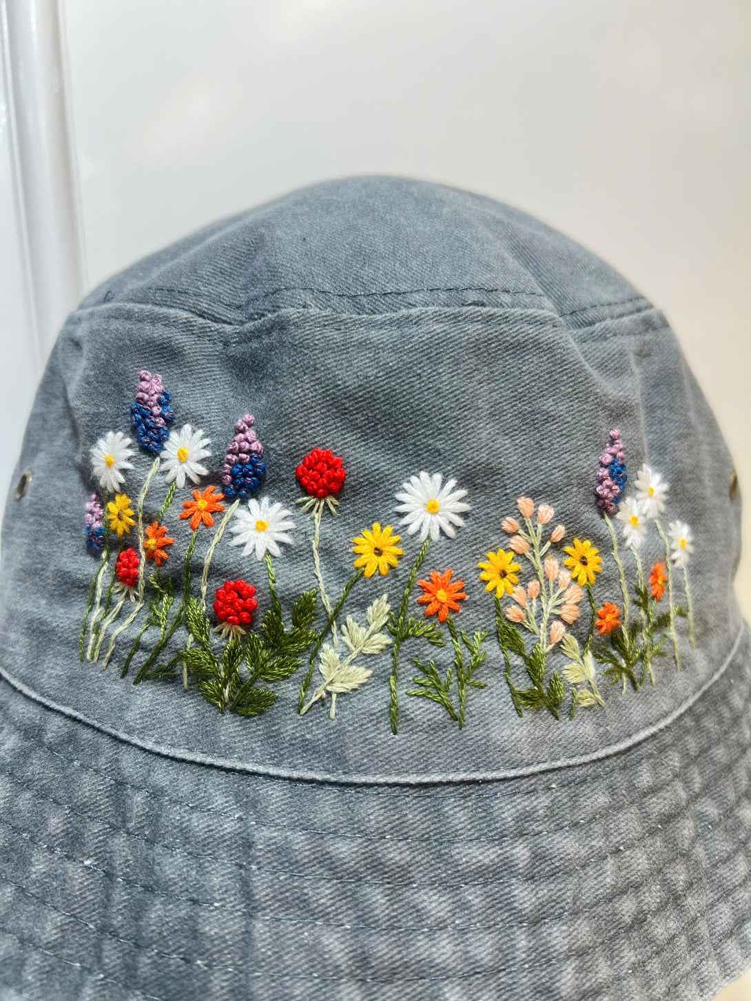 Stitchery Zone Flower Hand Embroidered Bucket Hat with colorful floral designs on gray fabric