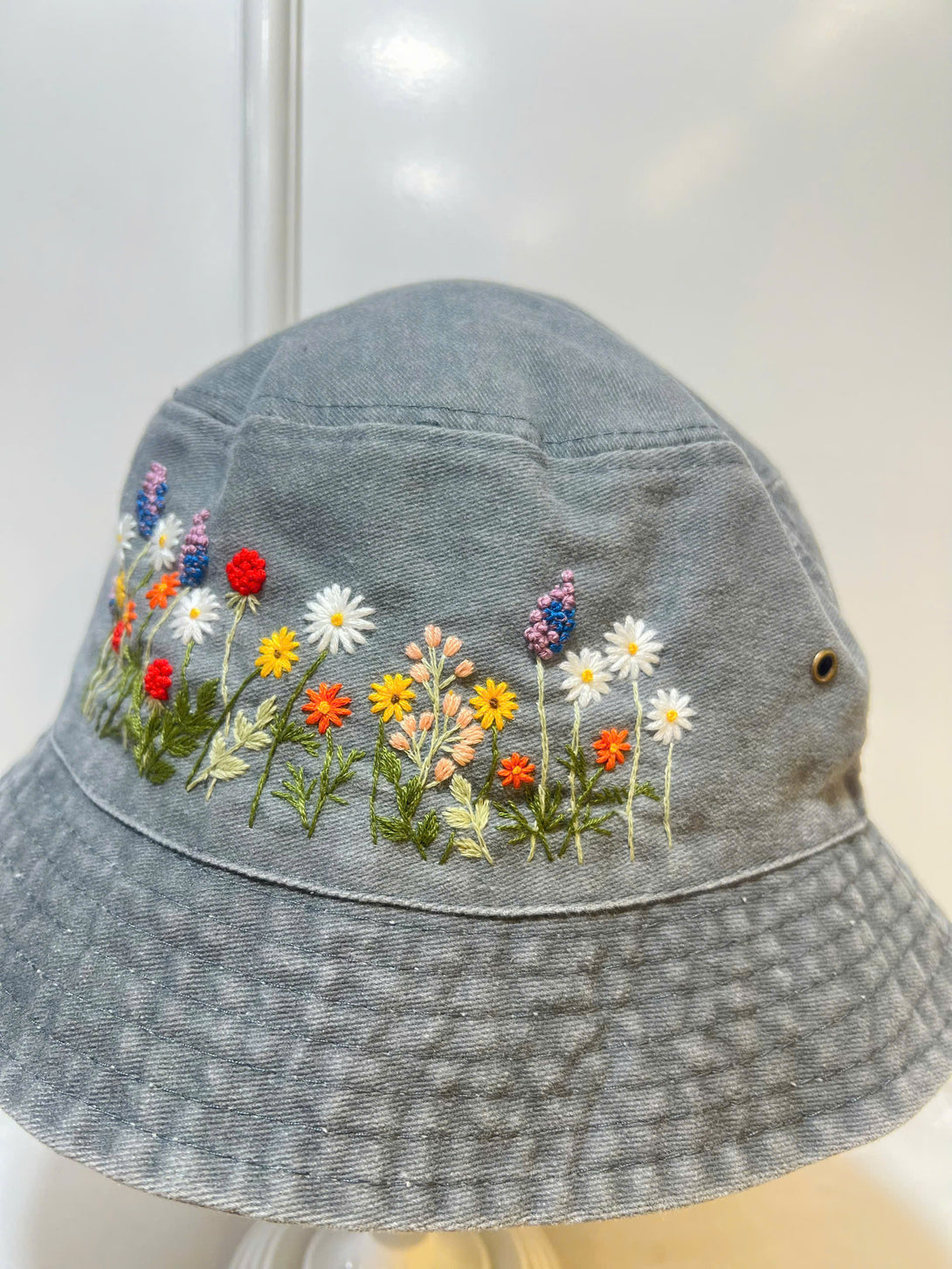 Gray Flower Hand Embroidered Bucket Hat with colorful floral designs by Stitchery Zone